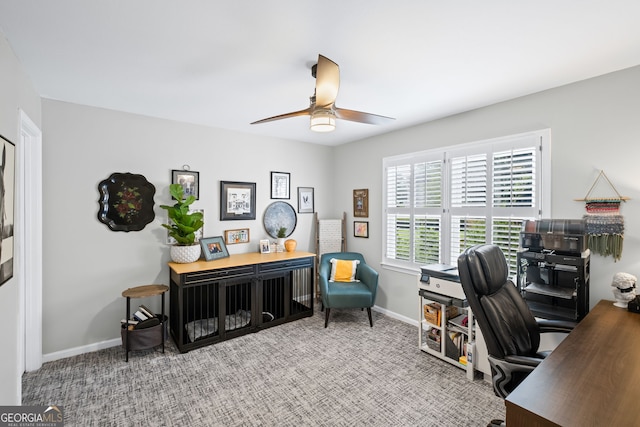 carpeted office featuring ceiling fan and baseboards