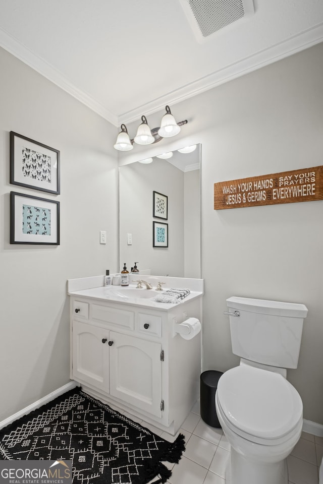 half bathroom featuring crown molding, vanity, toilet, tile patterned floors, and baseboards