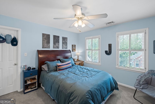 carpeted bedroom featuring a ceiling fan and baseboards