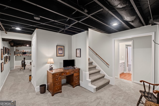 carpeted home office with baseboards