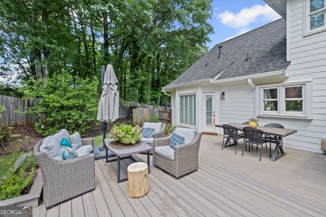 deck featuring an outdoor living space, outdoor dining area, and a fenced backyard