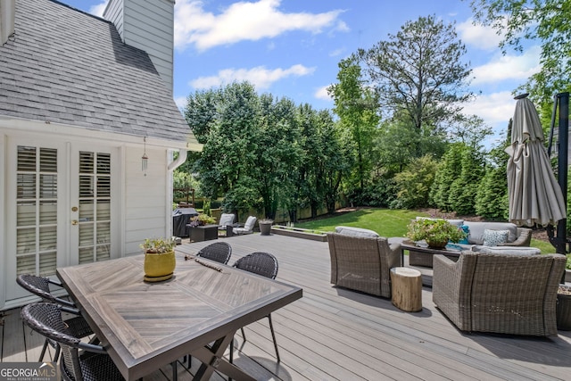 wooden terrace featuring an outdoor living space, outdoor dining area, and a yard