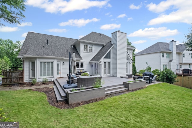 back of house with outdoor lounge area, a patio, roof with shingles, and a chimney
