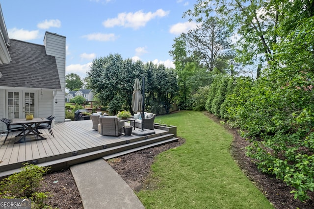view of grassy yard featuring an outdoor living space, outdoor dining area, and a wooden deck