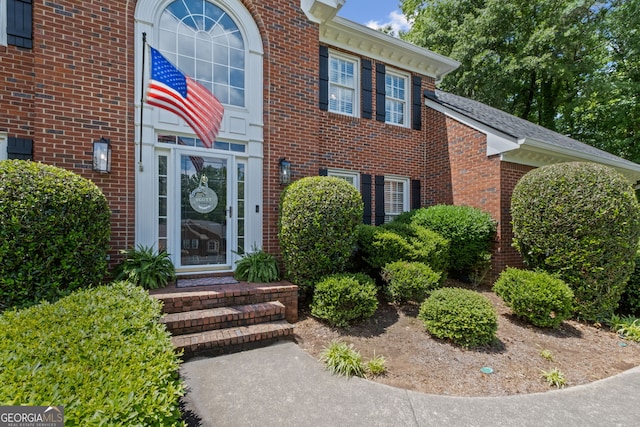 doorway to property with brick siding