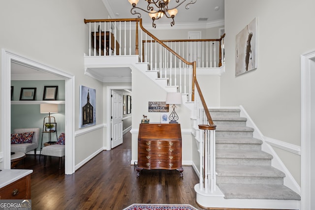 stairway featuring a chandelier, wood finished floors, crown molding, and baseboards
