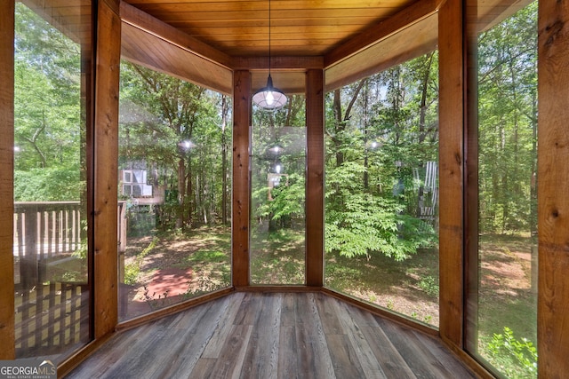 unfurnished sunroom with wood finished floors and wooden ceiling