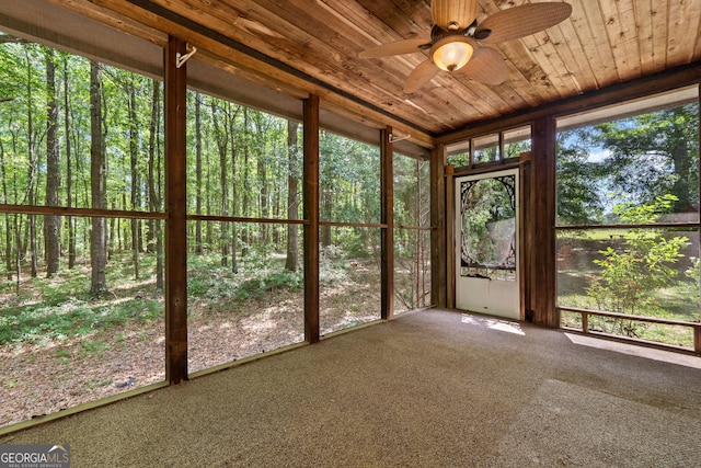unfurnished sunroom featuring a ceiling fan