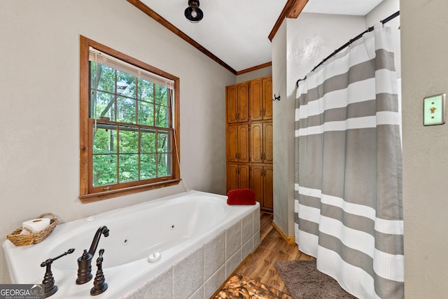 full bath with wood finished floors, crown molding, a whirlpool tub, and a shower with shower curtain
