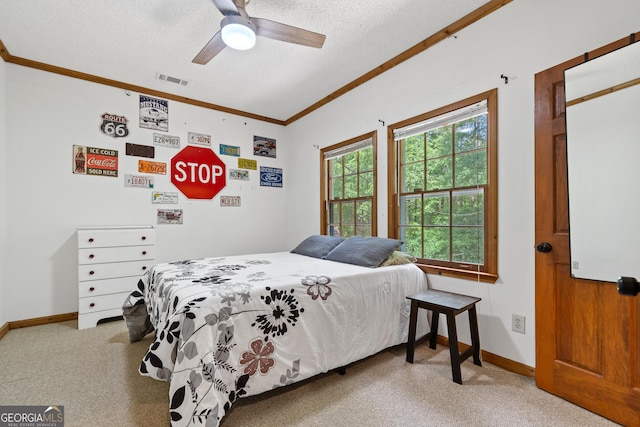 carpeted bedroom with multiple windows, a textured ceiling, baseboards, crown molding, and lofted ceiling