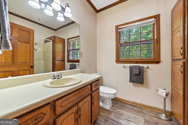 full bath with crown molding, healthy amount of natural light, wood finished floors, walk in shower, and toilet