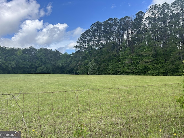 view of yard with a view of countryside and a wooded view