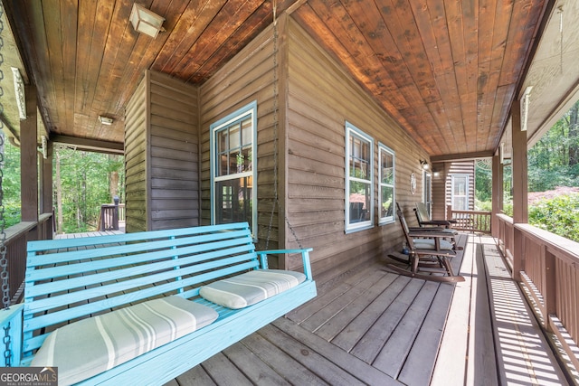 wooden terrace with a porch