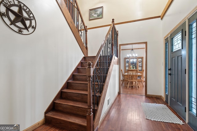 1627 Leguin Mill Rd, Locust Grove, GA 30248 - entryway featuring a chandelier, a towering ceiling, stairs, hardwood / wood-style flooring, and baseboards
