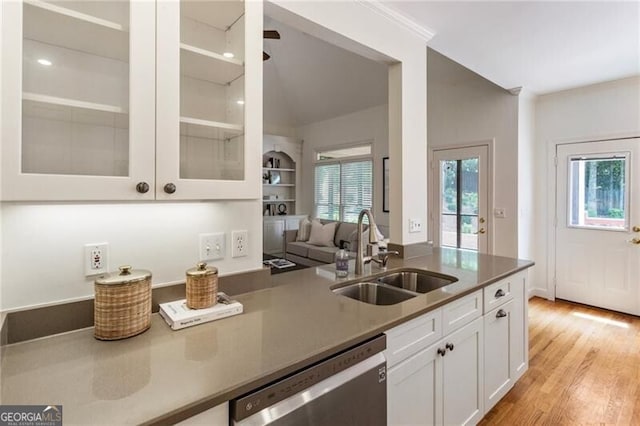 kitchen featuring a sink, dishwasher, white cabinetry, glass insert cabinets, and light wood finished floors
