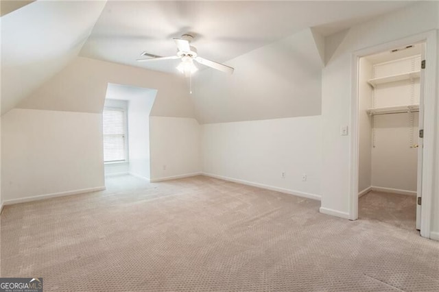 bonus room featuring light colored carpet, ceiling fan, vaulted ceiling, and baseboards