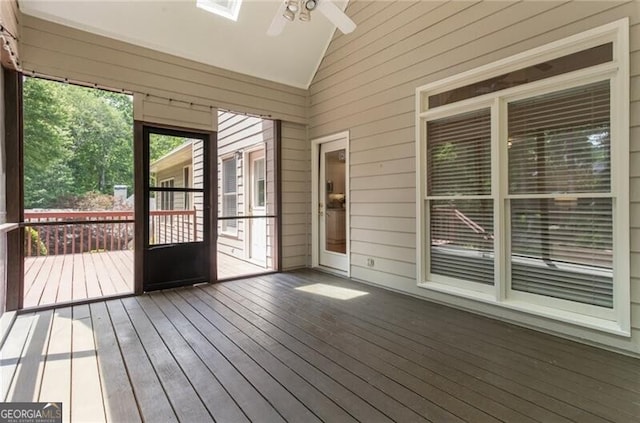 unfurnished sunroom featuring vaulted ceiling and ceiling fan