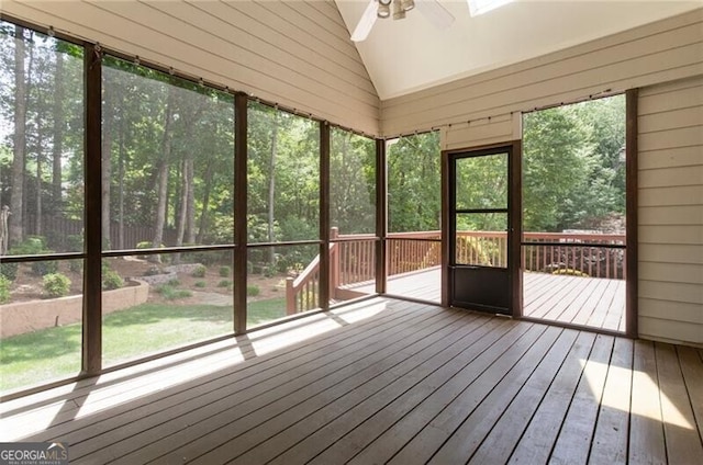 unfurnished sunroom featuring ceiling fan, lofted ceiling, and plenty of natural light