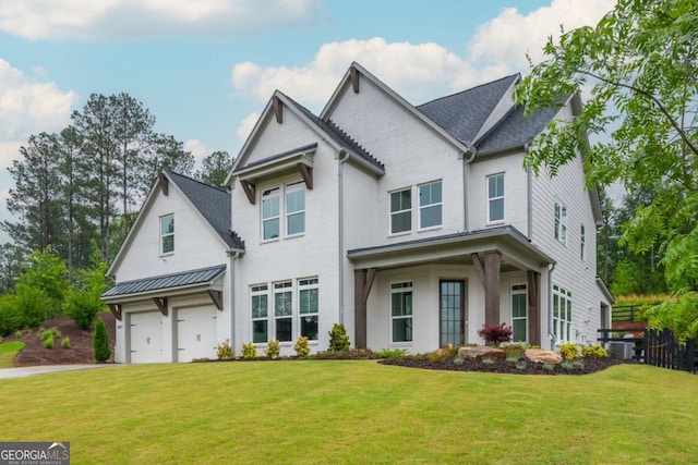 view of front of home featuring driveway, a front lawn, brick siding, and an attached garage