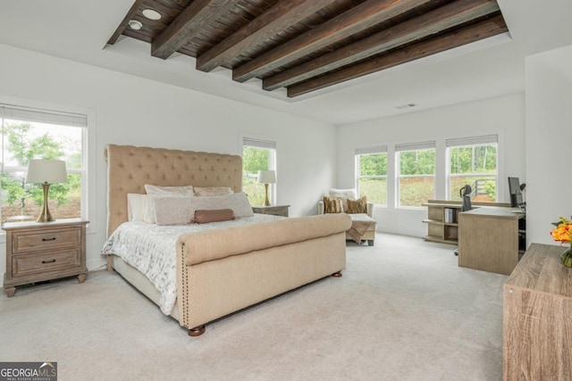 bedroom with light colored carpet and beam ceiling