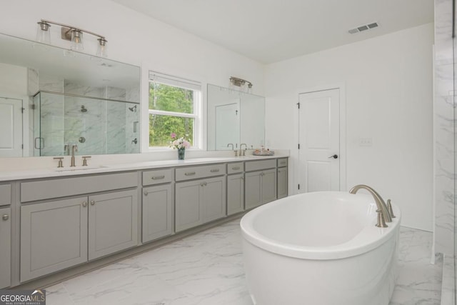 full bath with marble finish flooring, a marble finish shower, double vanity, and a freestanding tub