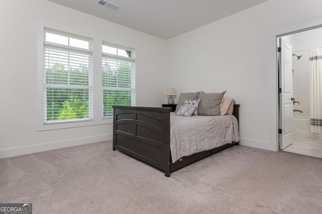 bedroom featuring carpet floors, baseboards, and connected bathroom