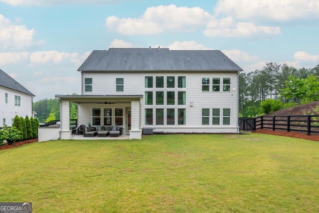 rear view of house featuring outdoor lounge area, a ceiling fan, and a patio