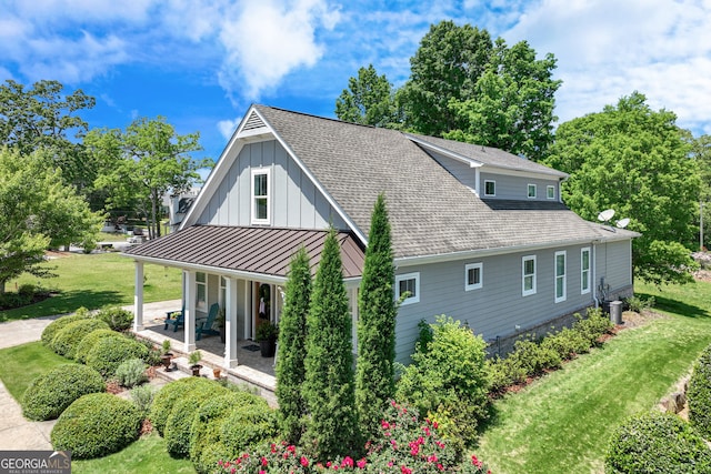 131 Village Dr, Clarkesville, GA 30523 - view of property exterior featuring a porch, a lawn, board and batten siding, and a standing seam roof