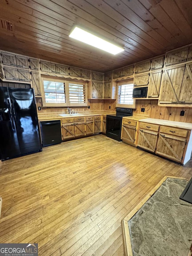 456 Pickelsimer Rd, Blairsville, GA 30512 - kitchen with black appliances, wooden ceiling, wooden walls, light countertops, and light wood-style flooring