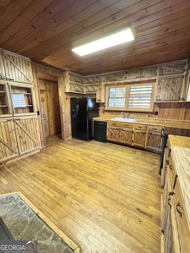 456 Pickelsimer Rd, Blairsville, GA 30512 - kitchen with black appliances, a sink, wood walls, light wood-style floors, and wood ceiling