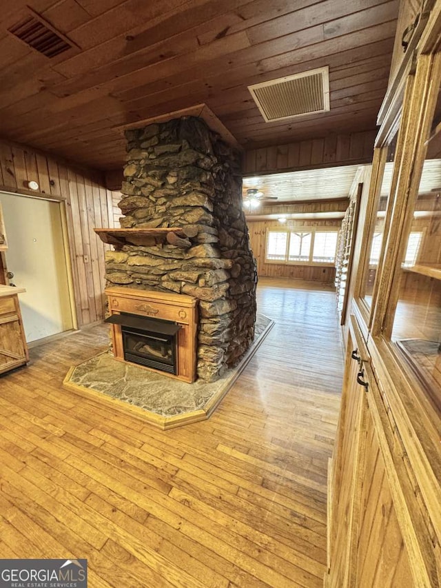 456 Pickelsimer Rd, Blairsville, GA 30512 - unfurnished living room with wood ceiling, a fireplace, hardwood / wood-style floors, and wooden walls
