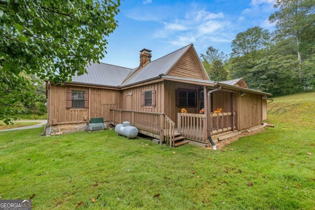 456 Pickelsimer Rd, Blairsville, GA 30512 - rear view of property with a lawn, metal roof, a chimney, a wooden deck, and central AC
