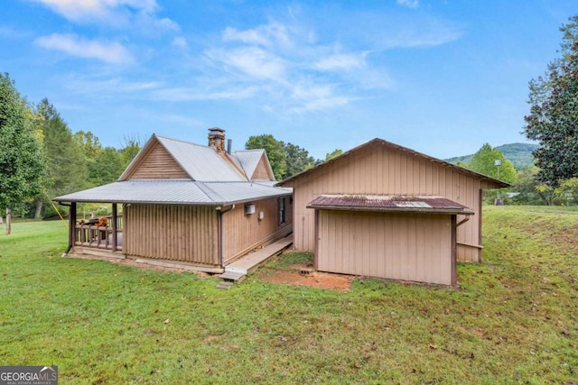 456 Pickelsimer Rd, Blairsville, GA 30512 - rear view of house with a yard, metal roof, and a chimney