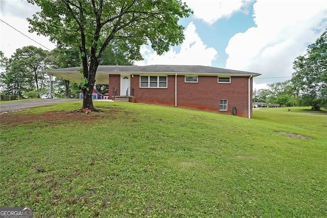 629 Birchwood Rd, Marietta, GA 30060 - ranch-style house with asphalt driveway, brick siding, a front lawn, and a carport