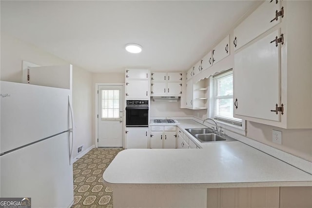 629 Birchwood Rd, Marietta, GA 30060 - kitchen featuring freestanding refrigerator, oven, a sink, open shelves, and light countertops