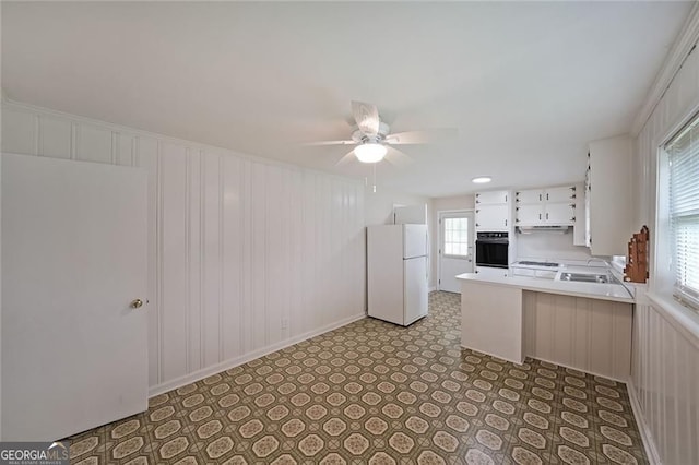 629 Birchwood Rd, Marietta, GA 30060 - kitchen with white appliances, ceiling fan, light countertops, a peninsula, and white cabinets