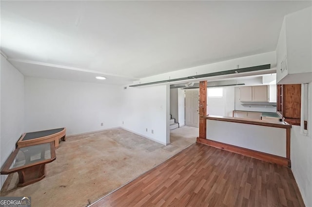 629 Birchwood Rd, Marietta, GA 30060 - unfurnished living room with stairway, light wood finished floors, and baseboards