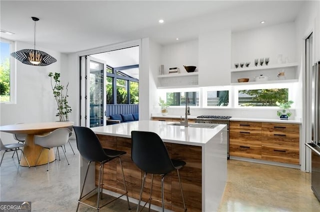 53 Daniel St SE, Atlanta, GA 30312 - kitchen with finished concrete floors, modern cabinets, light countertops, a kitchen island with sink, and recessed lighting