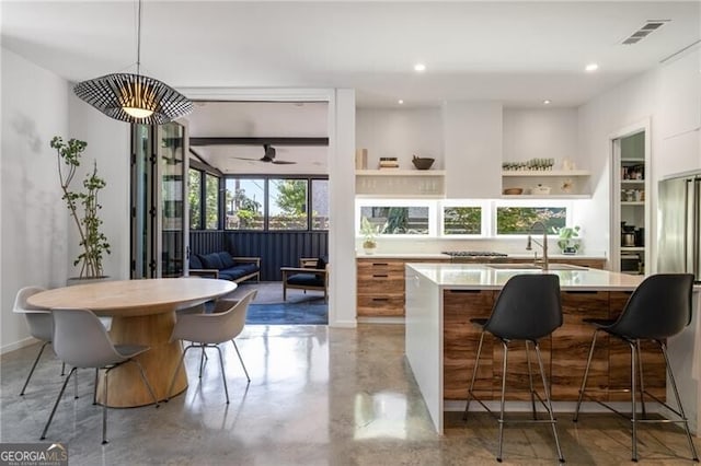 53 Daniel St SE, Atlanta, GA 30312 - kitchen featuring light countertops, a center island with sink, finished concrete floors, a ceiling fan, and recessed lighting