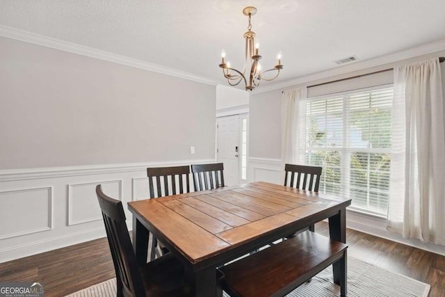 309 Nashview Trl, Allenhurst, GA 31301 - dining space featuring a chandelier, crown molding, dark wood-style flooring, a decorative wall, and a wainscoted wall