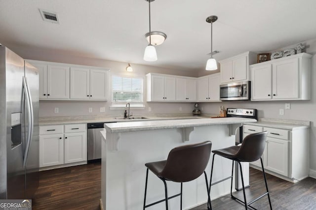 309 Nashview Trl, Allenhurst, GA 31301 - kitchen with appliances with stainless steel finishes, dark wood-style flooring, a sink, white cabinetry, and light countertops
