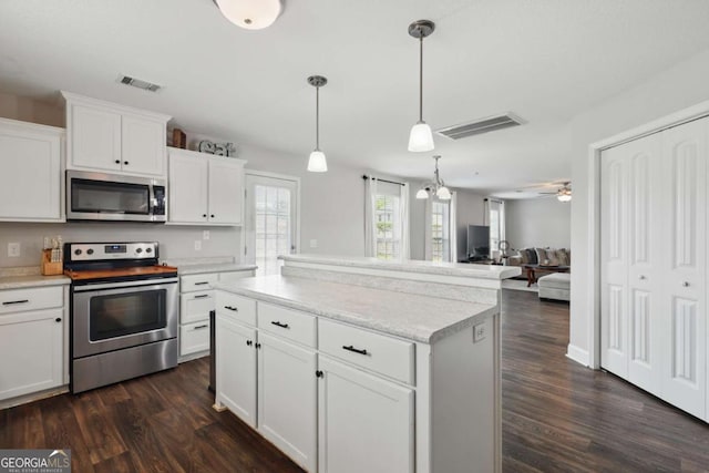 309 Nashview Trl, Allenhurst, GA 31301 - kitchen with stainless steel appliances, dark wood-style floors, light countertops, and white cabinetry