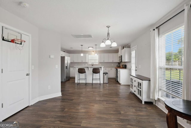 309 Nashview Trl, Allenhurst, GA 31301 - kitchen featuring appliances with stainless steel finishes, a kitchen island, white cabinetry, and dark wood-type flooring