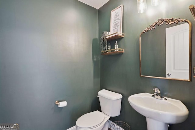 309 Nashview Trl, Allenhurst, GA 31301 - half bathroom with a sink, toilet, and baseboards