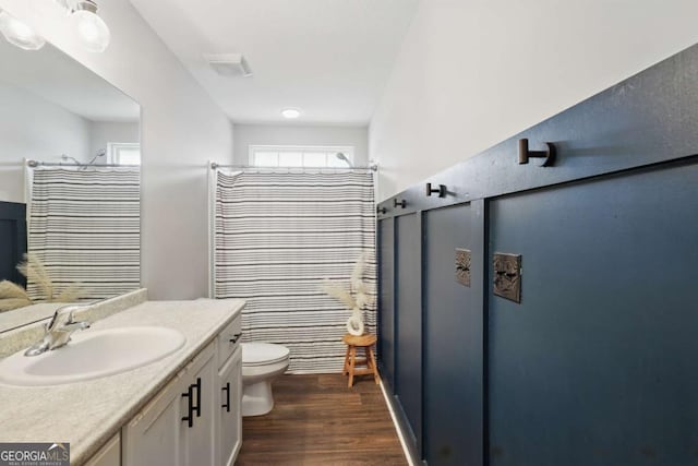 309 Nashview Trl, Allenhurst, GA 31301 - full bath featuring wood finished floors, vanity, toilet, and a shower with shower curtain