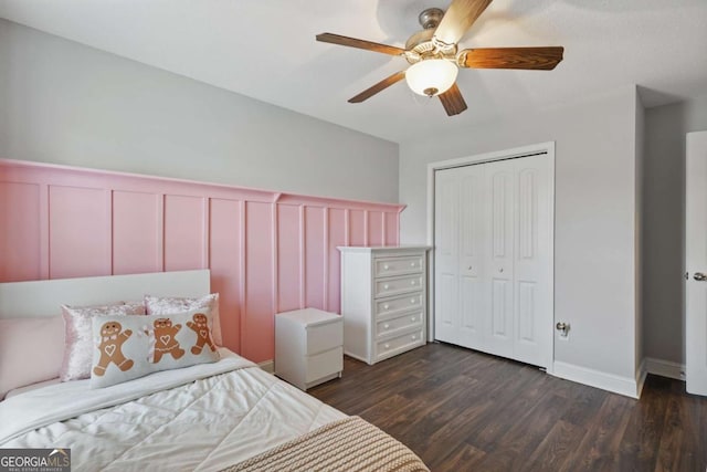 309 Nashview Trl, Allenhurst, GA 31301 - bedroom with a decorative wall, dark wood finished floors, a closet, wainscoting, and ceiling fan