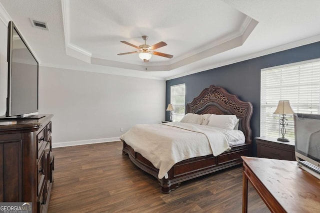 309 Nashview Trl, Allenhurst, GA 31301 - bedroom featuring a tray ceiling, dark wood finished floors, crown molding, baseboards, and ceiling fan