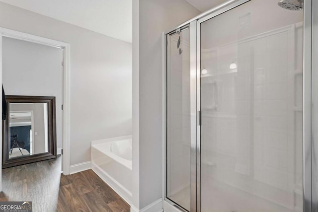 309 Nashview Trl, Allenhurst, GA 31301 - bathroom with a shower stall, a garden tub, baseboards, and wood finished floors