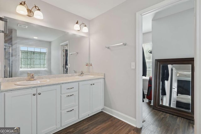 309 Nashview Trl, Allenhurst, GA 31301 - full bath with baseboards, wood finished floors, double vanity, and an enclosed shower