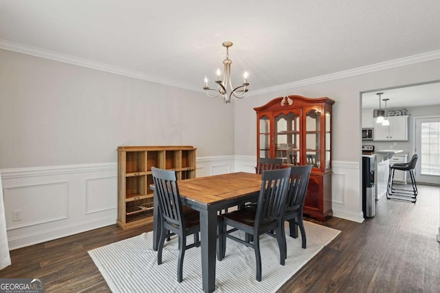 309 Nashview Trl, Allenhurst, GA 31301 - dining area featuring a chandelier, dark wood finished floors, crown molding, and wainscoting